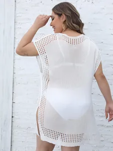Detailed back view of white crochet beach cover-up with open knit patterns and side slit