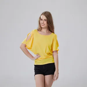 Studio shot of a model wearing a yellow top with stylish cut-out shoulder details