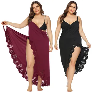 Detailed view of plus size beach cover-up with hollow-out floral hem and asymmetrical cut.