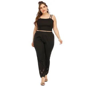 Detail view of black plus size two-piece outfit with laser-cut floral hem on pants