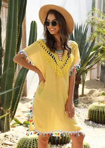Yellow V-neck beach cover-up with colorful tassels and crochet detailing on model
