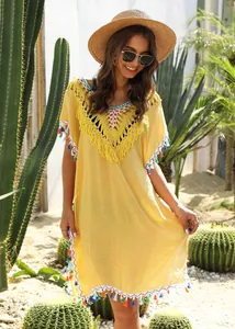 Bohemian yellow crochet V-neck beach cover-up dress featuring vibrant colorful tassels.