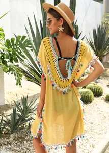 Yellow boho beach cover-up featuring colorful tassels and backless crochet V-neck