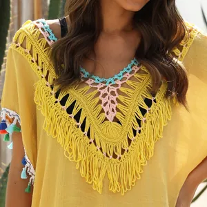 Detailed view of yellow boho beach cover-up with multi-colored crochet neckline and tassels