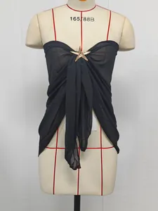Close-up of black chiffon beach wrap featuring an elegant gold starfish metal accessory