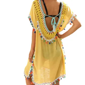 Yellow boho beach cover-up dress featuring crochet detailing, colorful tassels, and an open back