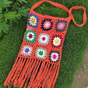 Handmade vintage granny square crochet crossbody bag with orange fringe and floral pattern