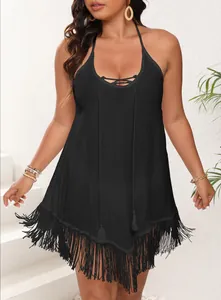 Detail of black plus size beach cover-up featuring fringe hem and lace-up front