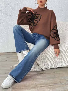 Brown mock neck knit sweater with black ribbon flower embroidery and lantern sleeves.
