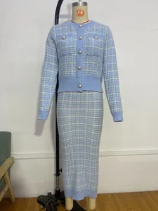 Elegant light blue plaid knitted two-piece set with cardigan and long skirt on mannequin