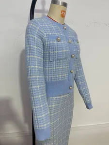 Detail view of light blue plaid knit cardigan and pencil skirt set on dress form