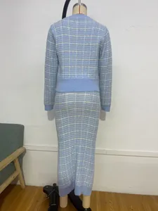 Detailed back view of a light blue plaid knit cardigan and midi skirt set on a mannequin