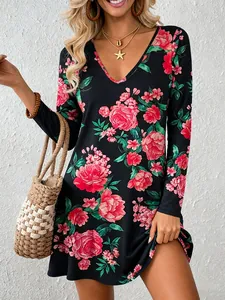 Detail of a women's black long sleeve V-neck A-line dress with vibrant pink floral print