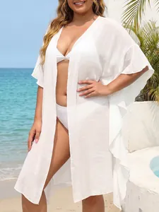Flowing white ruffle beach cardigan showing lightweight fabric and loose holiday fit