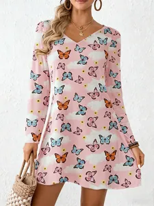 Detail shot of a pink long sleeve A-line dress featuring a colorful butterfly pattern and V-neck.