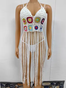 Hand-crocheted boho beach cover-up with colorful floral motifs and long white tassels