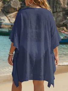 Detailed back view of a navy blue loose ruffle beach cover-up with textured fabric