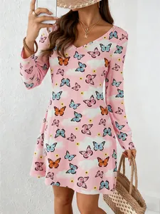 Detail view of women's pink V-neck long sleeve dress with butterfly and cloud prints