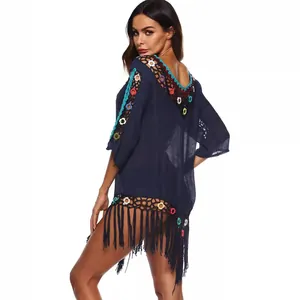 Stylish navy blue beach cover-up featuring colorful crochet patchwork and tassel hem