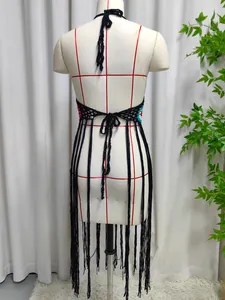 Back view of handmade crochet beach cover-up with long fringes and floral details.