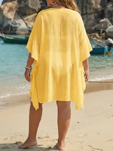 Back view of a yellow plus size ruffle beach cover-up in a lightweight fabric.