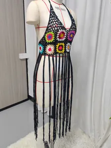 Detailed view of handmade crochet bikini cover-up with multi-color patterns and long fringes