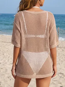 Back view of a beige crochet knit beach cover-up with mesh hollow-out design.