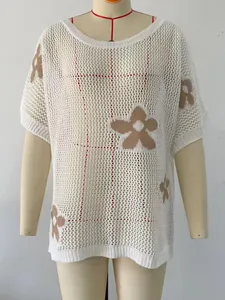 Detailed view of white mesh crochet beach cover-up with brown flower jacquard design