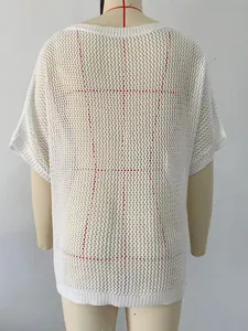 Rear detail of white crochet beach cover-up showing mesh jacquard pattern texture