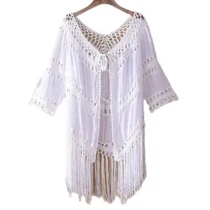 White crochet beach cover-up with tassel detail and lace hollow design