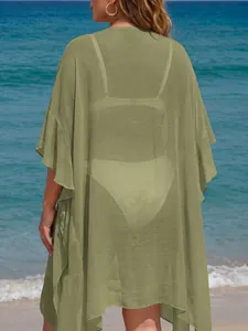 Back view of a plus size sage green ruffled beach cover-up cardigan showing sheer fabric