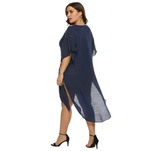 Back view of a plus-size navy blue beach cover-up with high slits and asymmetrical hem.