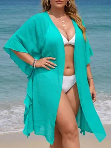 Turquoise plus size ruffle beach cover up cardigan over white bikini on sunny beach