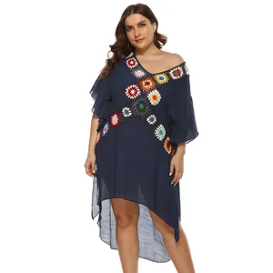 Full view of plus size navy beach dress with vibrant hand-crocheted floral patchwork