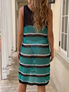 Back view of a vibrant striped crochet beach cover-up featuring a hollow knit design