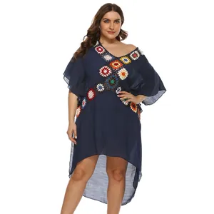 Close-up of plus size navy beach cover-up with colorful crochet flower patches.
