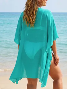 Back view of turquoise ruffle beach cover-up showing semi-transparent fabric texture