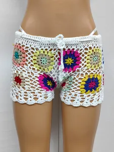 Detailed view of handmade crochet granny square beach shorts with colorful patterns