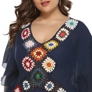 Detail view of the colorful crochet flower neckline on a navy beach cover-up.