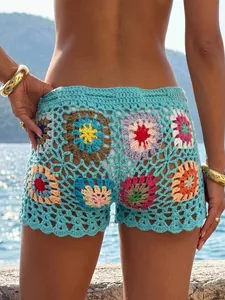 Back view detail of colorful granny square crochet beach shorts with floral patterns