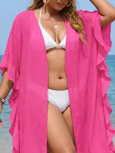Close-up of pink ruffle beach cover-up with textured fabric for a vibrant resort look