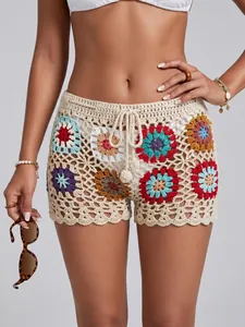 Close-up view of handmade crochet beach shorts featuring vibrant colorful granny squares