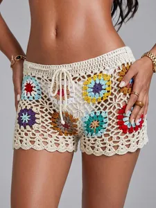Detailed view of handmade crochet beach shorts with colorful grandmother square patterns.