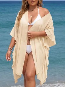 Detailed view of beige plus size beach cover-up featuring flowing ruffle trim details