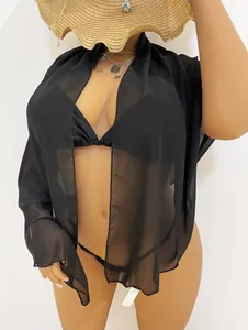 Detailed view of sheer black chiffon beach cover-up with lightweight fabric texture.