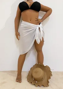 Sheer white chiffon beach sarong wrap skirt tied on a mannequin with a straw hat