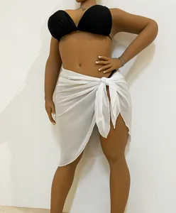Close-up detail of a white semi-sheer chiffon tie-up beach sarong skirt for women