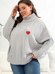 Front view detail of a plus size grey turtleneck sweater with a red heart patch