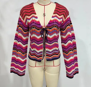 Detail shot of a vibrant rainbow wave knit cardigan featuring tie-front closure and bell sleeves