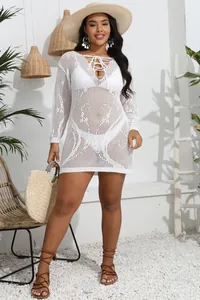 Close-up of a white plus size crochet bikini cover-up featuring a deep V lace-up neck.